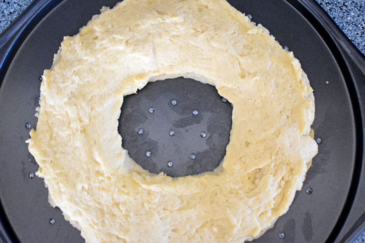 Unbaked gluten-free almond puff on round baking pan