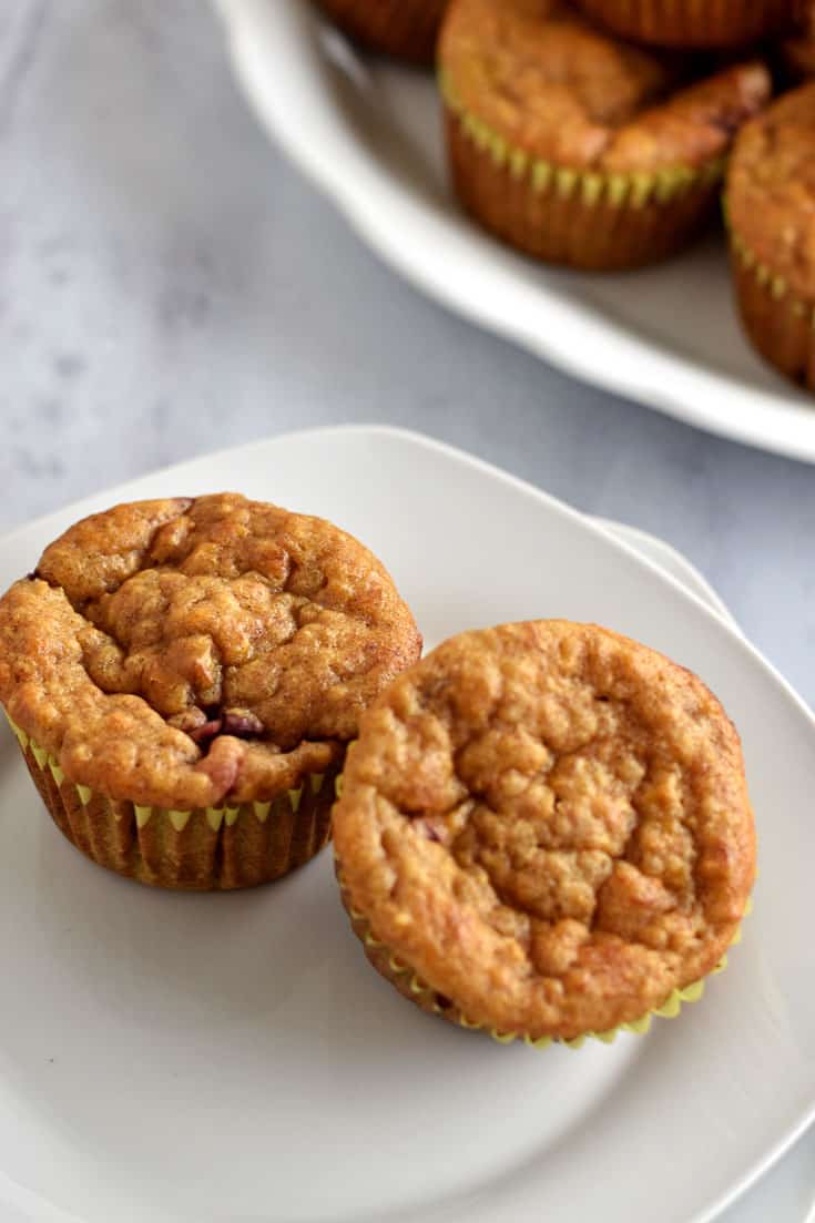 Two Healthy Quinoa Banana and Strawberry Muffins on a white plate