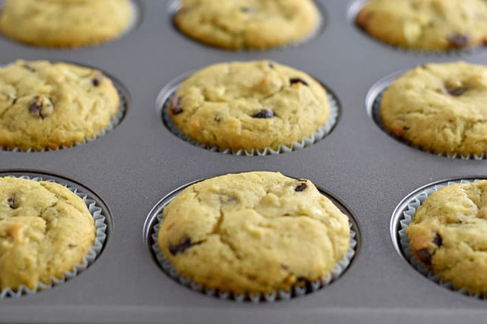 Muffin pan filled with baked gluten free chocolate chip banana muffins