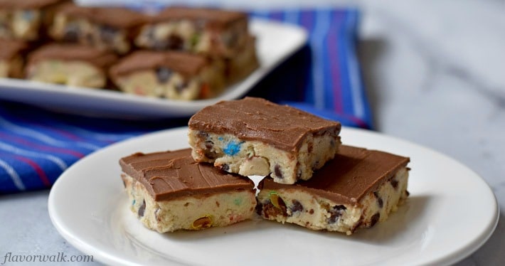 Stack of 3 No Bake Cookie Dough Bites on small white plate with more cookie dough bites on rectangular white plate in upper left corner