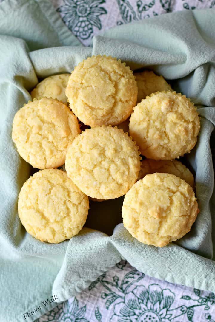 A cloth lined basket filled with sweet cornbread muffins