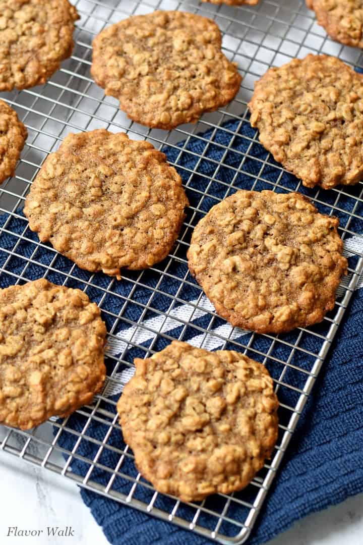 Banana Oatmeal Cookies cooling on a wire rack with a blue and white striped kitchen towel under the rack