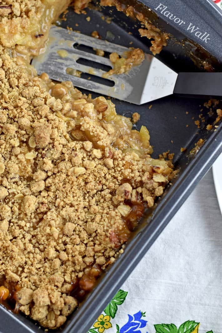 Overhead view of gluten free apple dessert in pan with two servings removed