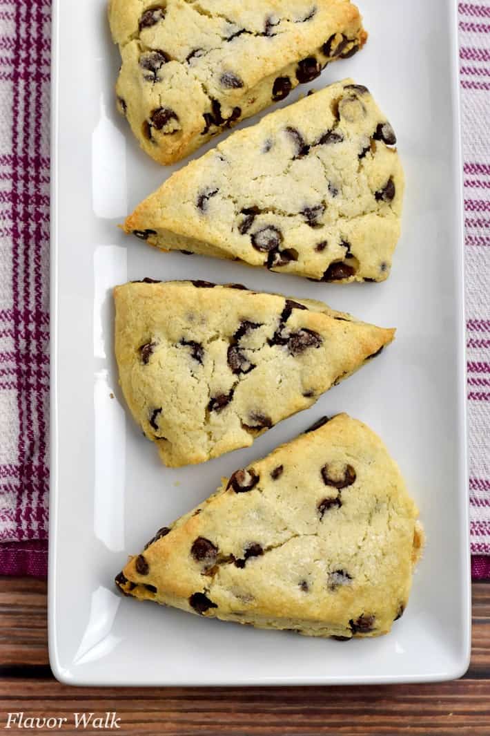 Overhead view of 4 baked Gluten Free Chocolate Chip Scones on a white rectangular plate