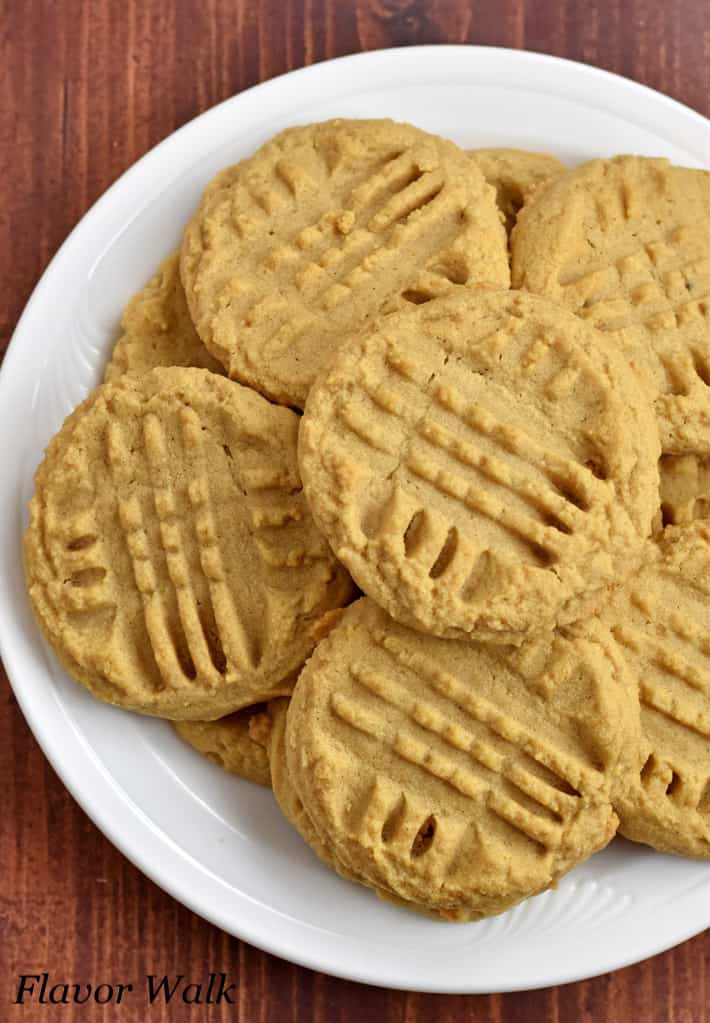 Overhead view of a stack of gluten free peanut butter cookies on a white plate.