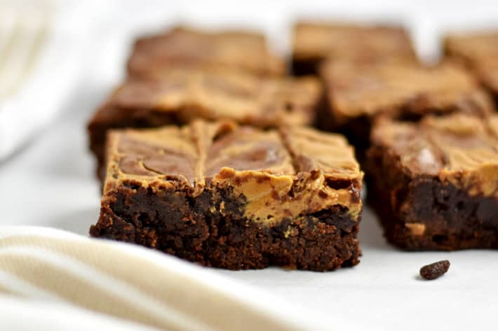 Close up view of gluten free peanut butter brownies on parchment paper.