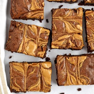 Overhead view of cut up gluten free peanut butter brownies on parchment paper.