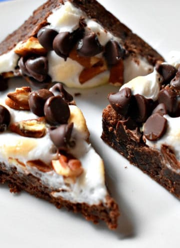 Three rocky road brownies on a white plate.