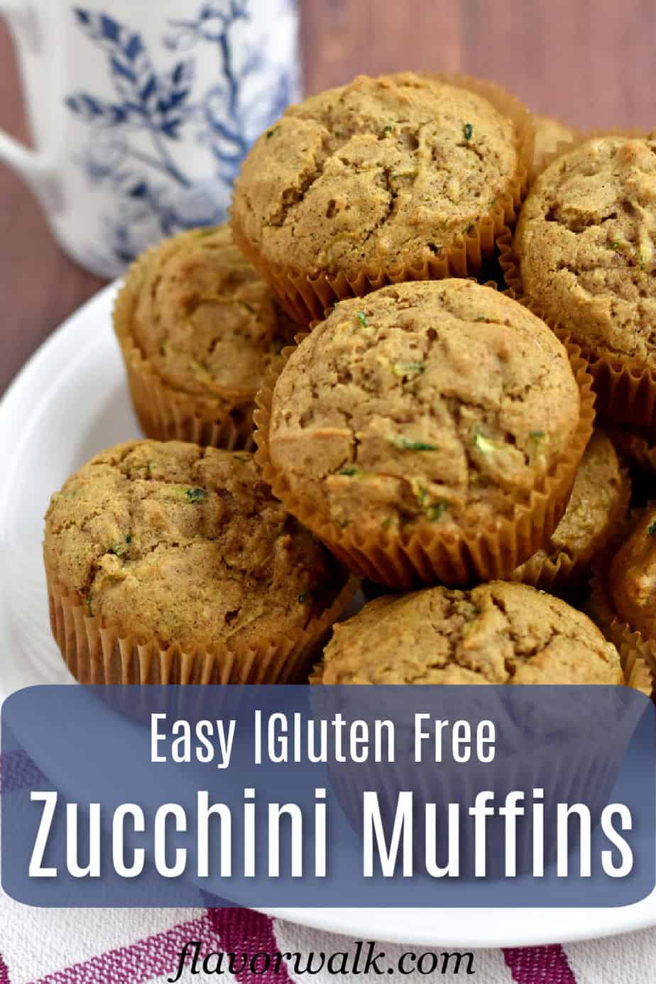 A stack of gluten free zucchini muffins on a round white plate with a blue and white text overlay.
