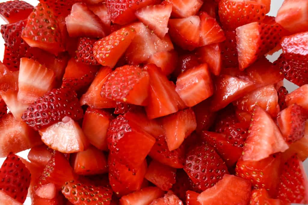 Close up overhead view of diced fresh strawberries.