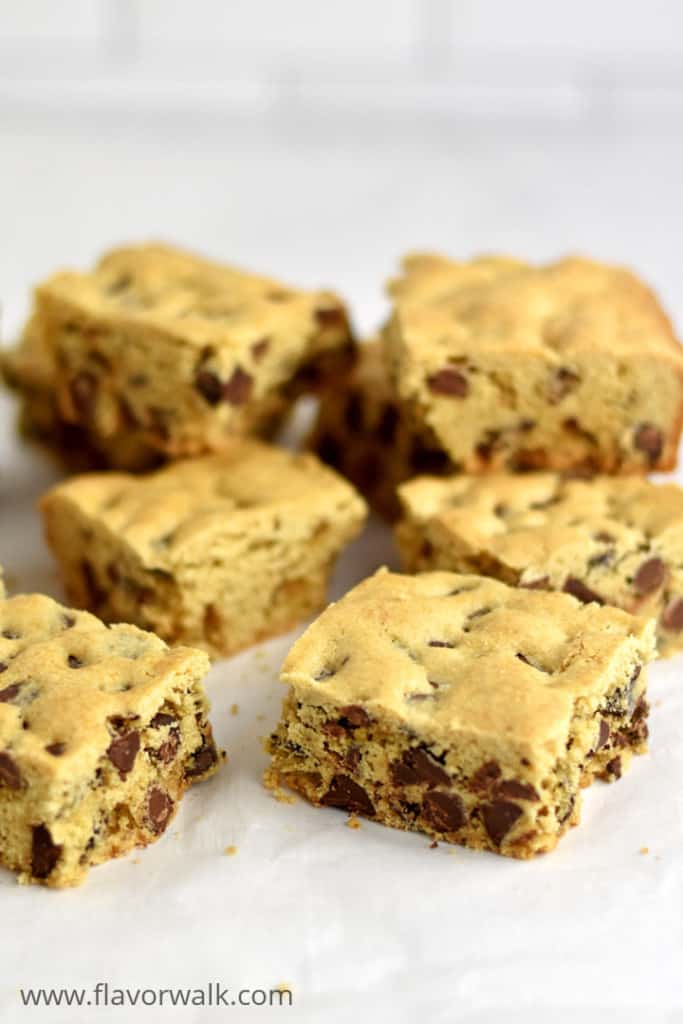 Gluten Free Chocolate Chip Cookie Bars stacked on parchment paper.