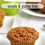 Close up view of one gluten free apple muffin with more muffins and a granny smith apple in the background. White overlay with green and black text near the top of image for Pinterest.