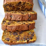 Close up view of slices of gluten free chocolate chip pumpkin bread on parchment paper.