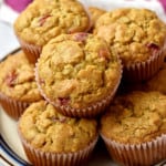 Close up view of a stack of gluten free cranberry muffins on round serving plate.