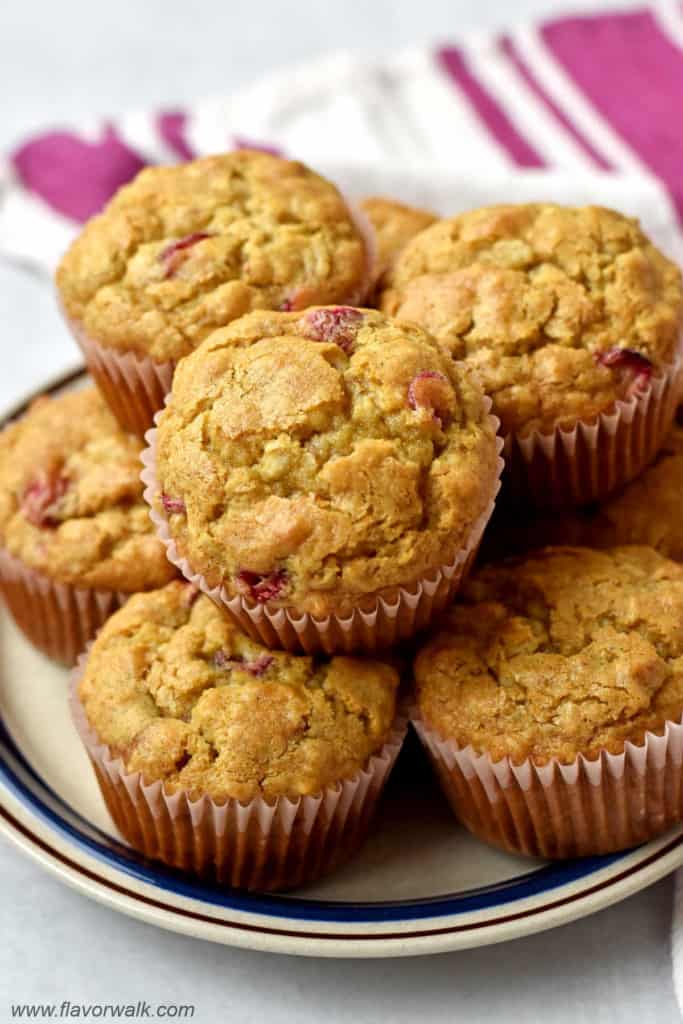 Close up view of a stack of gluten free cranberry muffins on round serving plate.