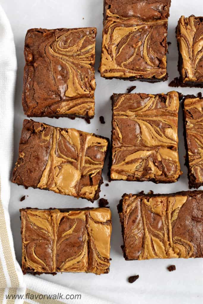 Overhead view of several gluten free peanut butter brownies on parchment paper.