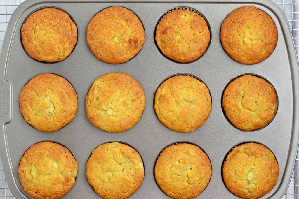 Overhead view of baked banana muffins in muffin pan.