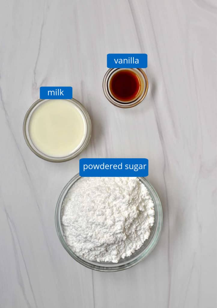 Ingredients, with labels, for easy cinnamon roll cake glaze.