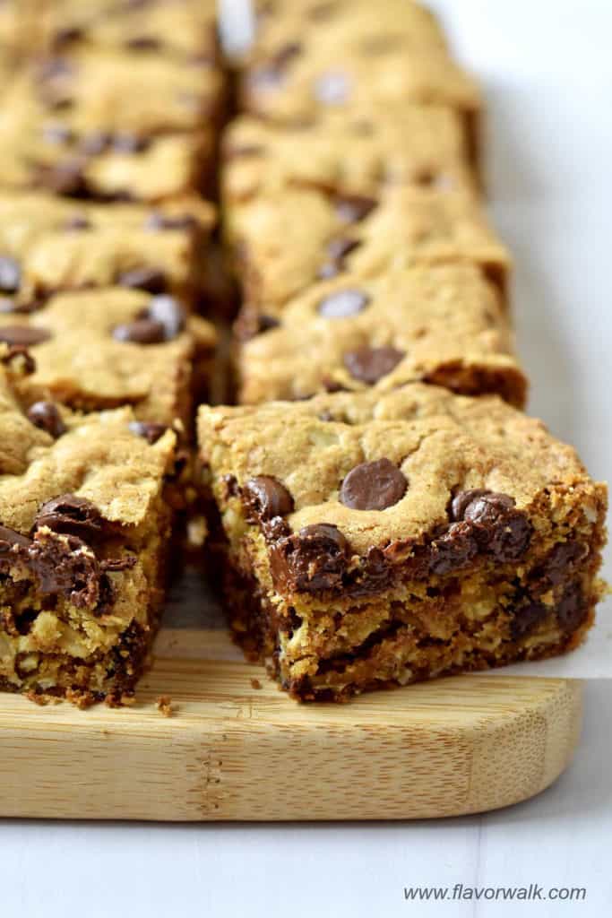 Close-up view of sliced gluten free oatmeal chocolate chip bars on a wood cutting board.