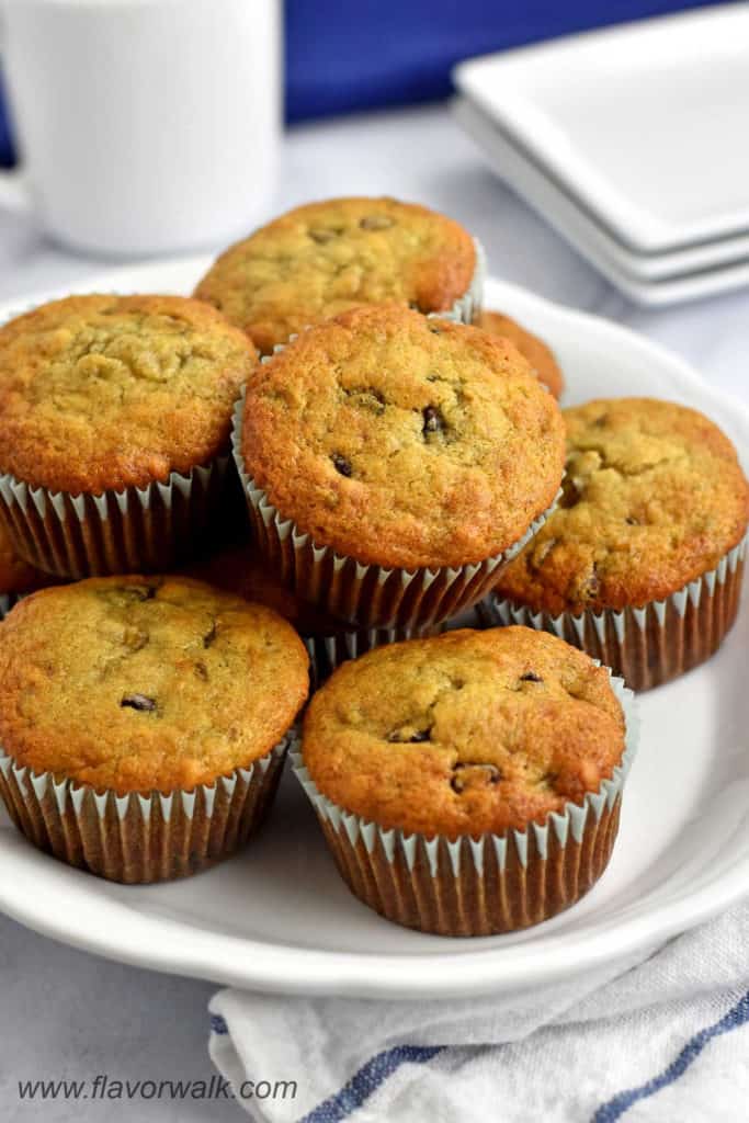 White serving plate filled with gluten free banana and chocolate chip muffins.