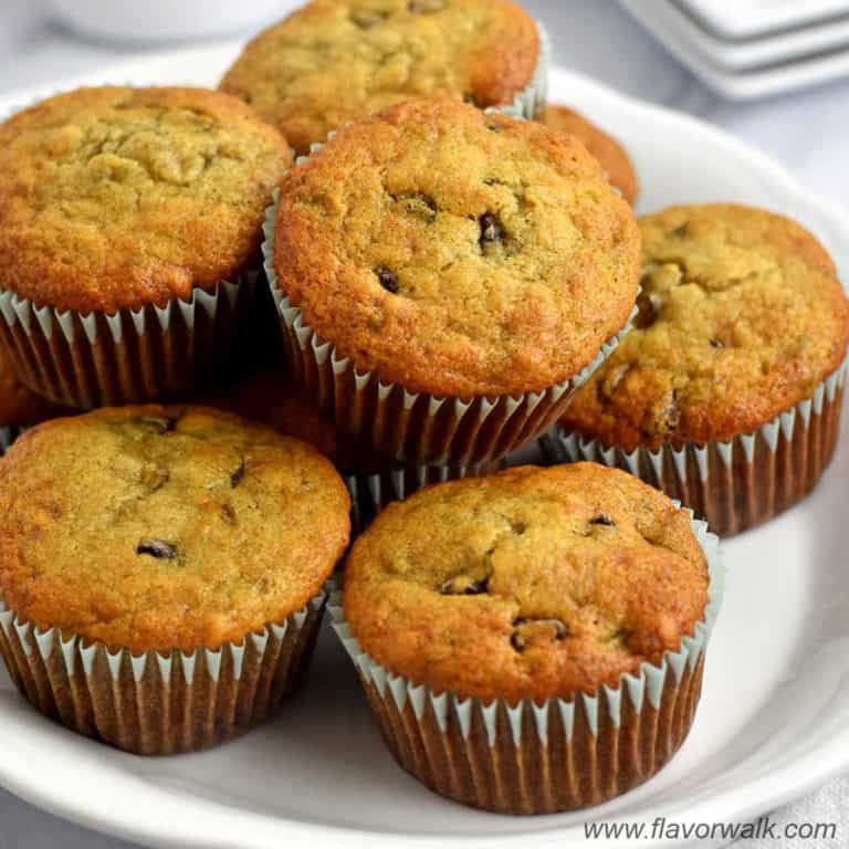 Stack of gluten free chocolate chip banana muffins on white serving plate.