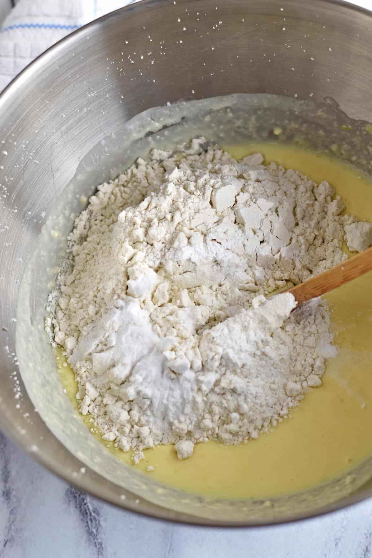 Dry ingredients being added to lemon blueberry bread batter.
