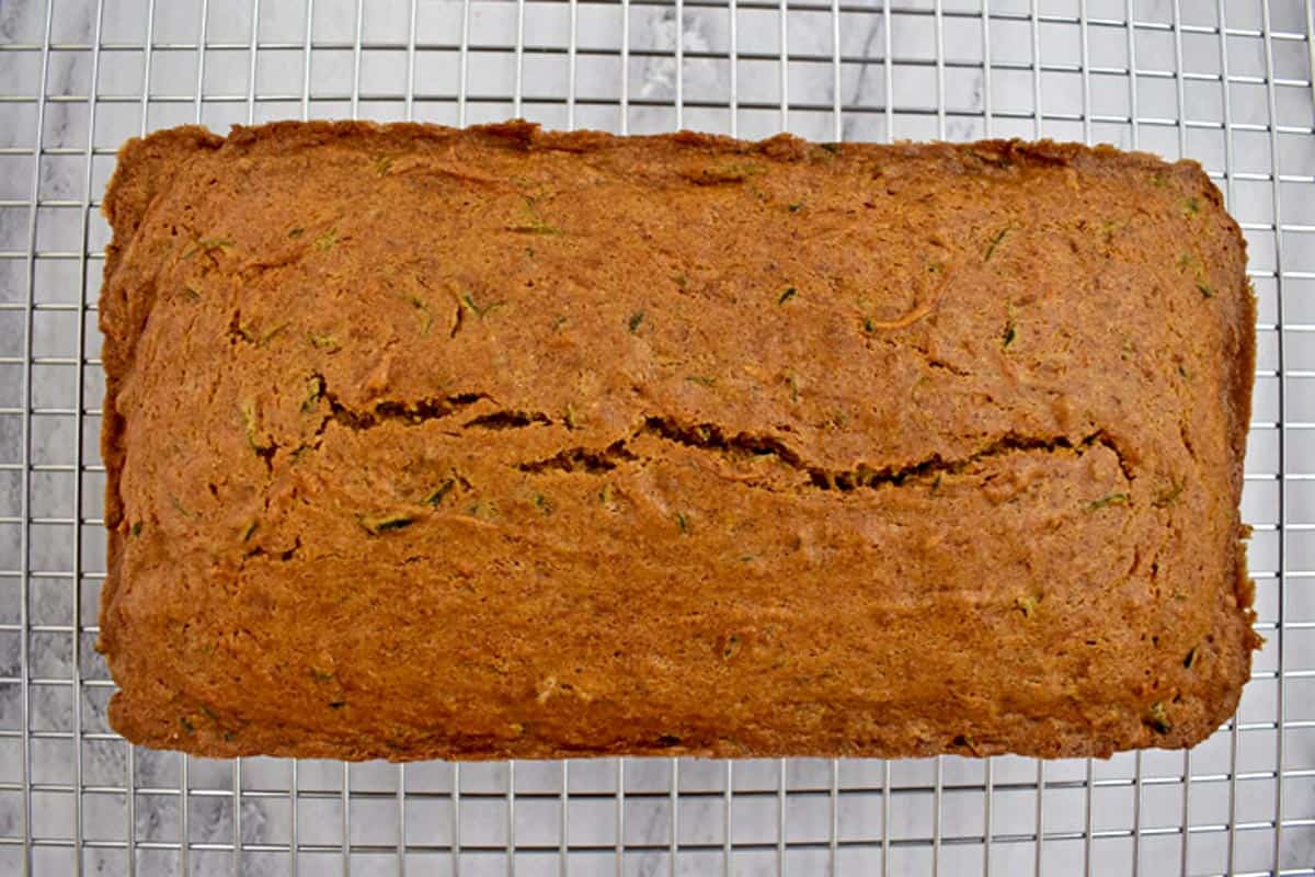 Gluten free zucchini bread cooling on a wire rack.