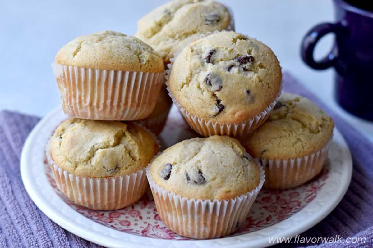 A stack of gluten free chocolate chip muffins on a round plate.