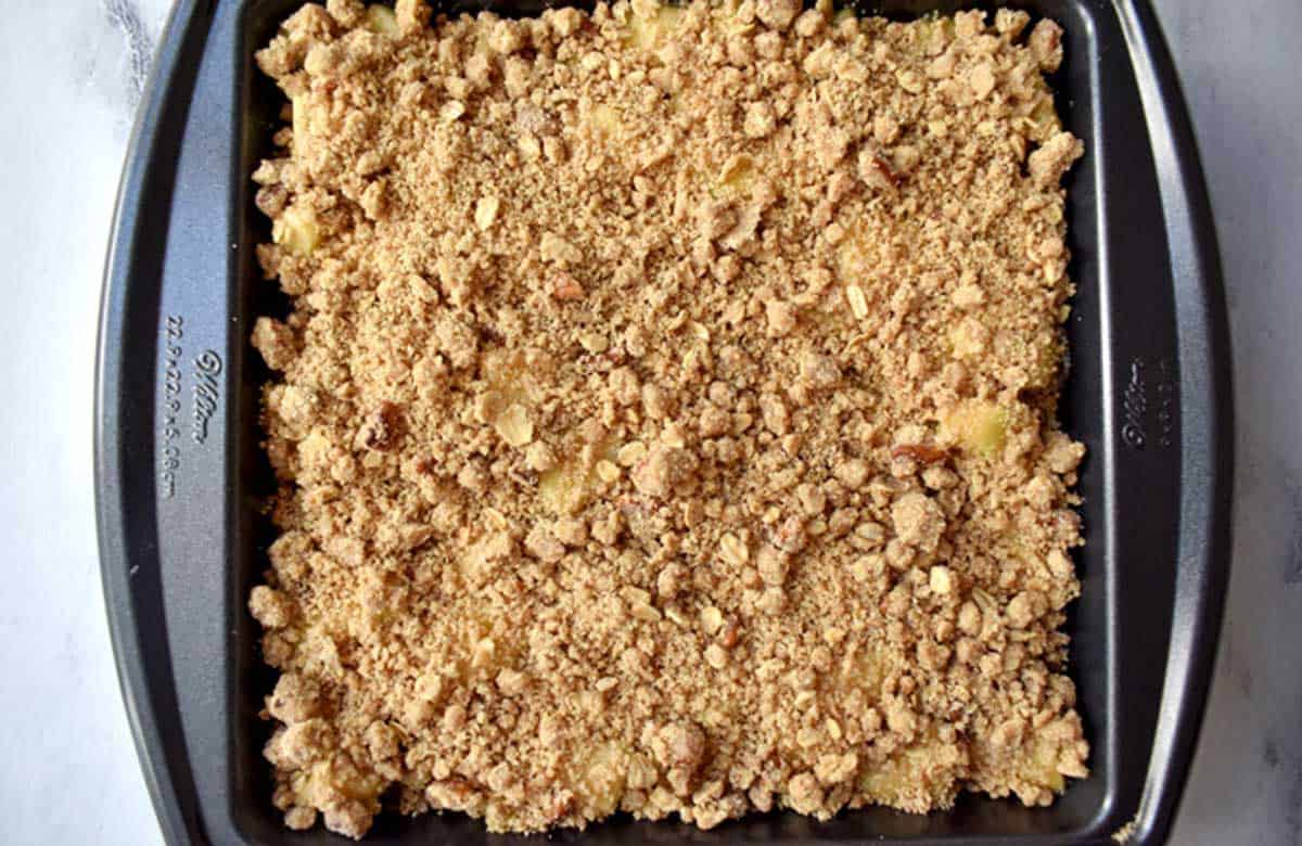 Unbaked gluten free apple dessert in 9x9-inch baking pan.