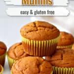 One gluten free pumpkin muffin stacked on other pumpkin muffins on kitchen counter with text overlay, "Pumpkin Muffins, Easy & Gluten Free."