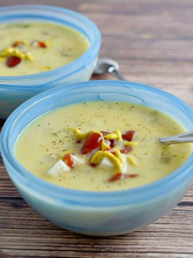 Two blue bowls filled with crockpot cheeseburger soup.
