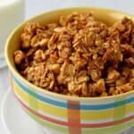 Peanut butter granola in a multi-colored cereal bowl.
