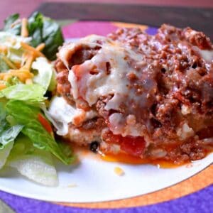 One serving of gluten free lasagna and a small green salad.