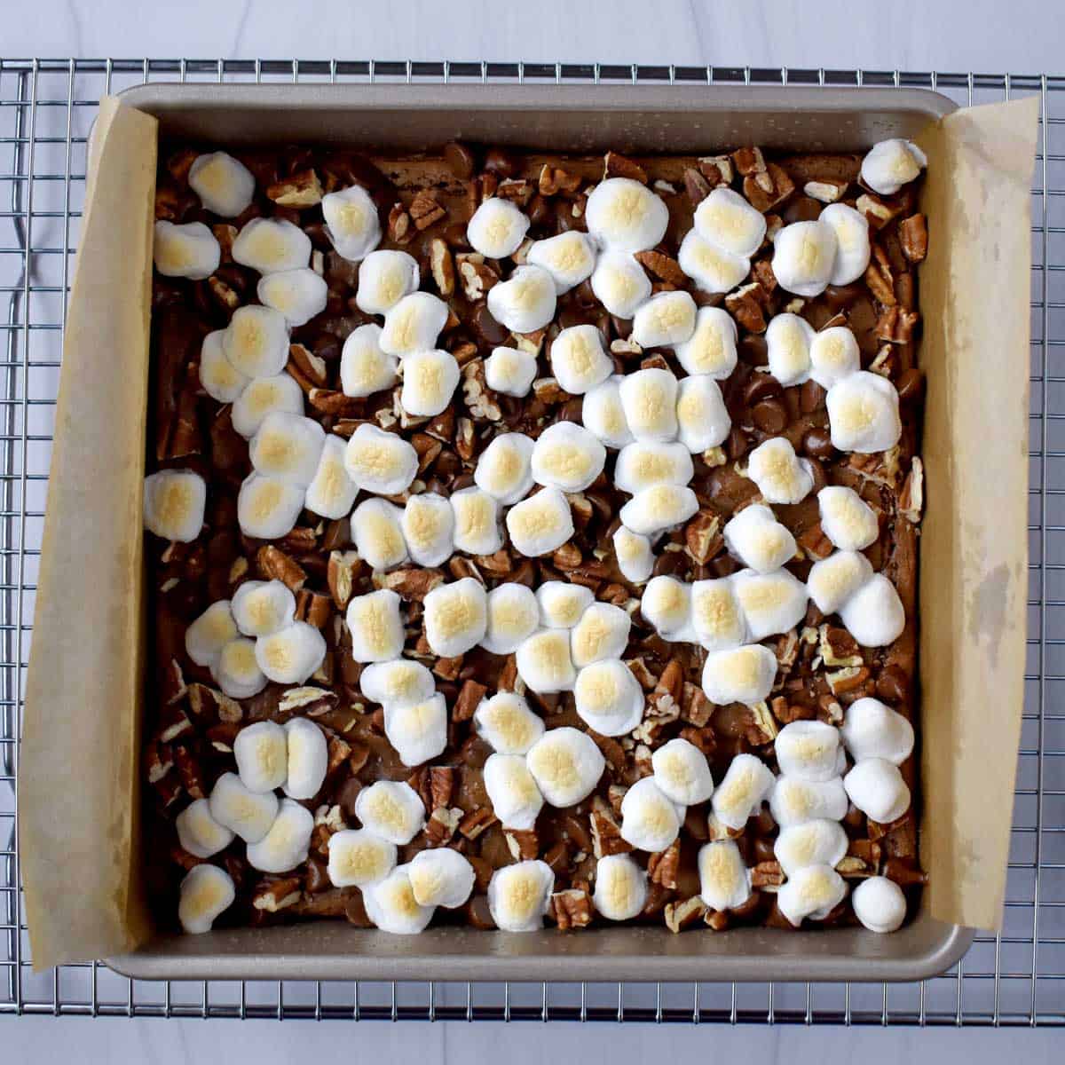 Overhead view of gluten free rocky road brownies in a parchment lined pan.