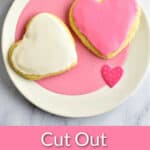 Two frosted gluten free sugar cookies on a pink and white plate with text overlay, "Cut Out Sugar Cookies, Easy & Gluten Free."