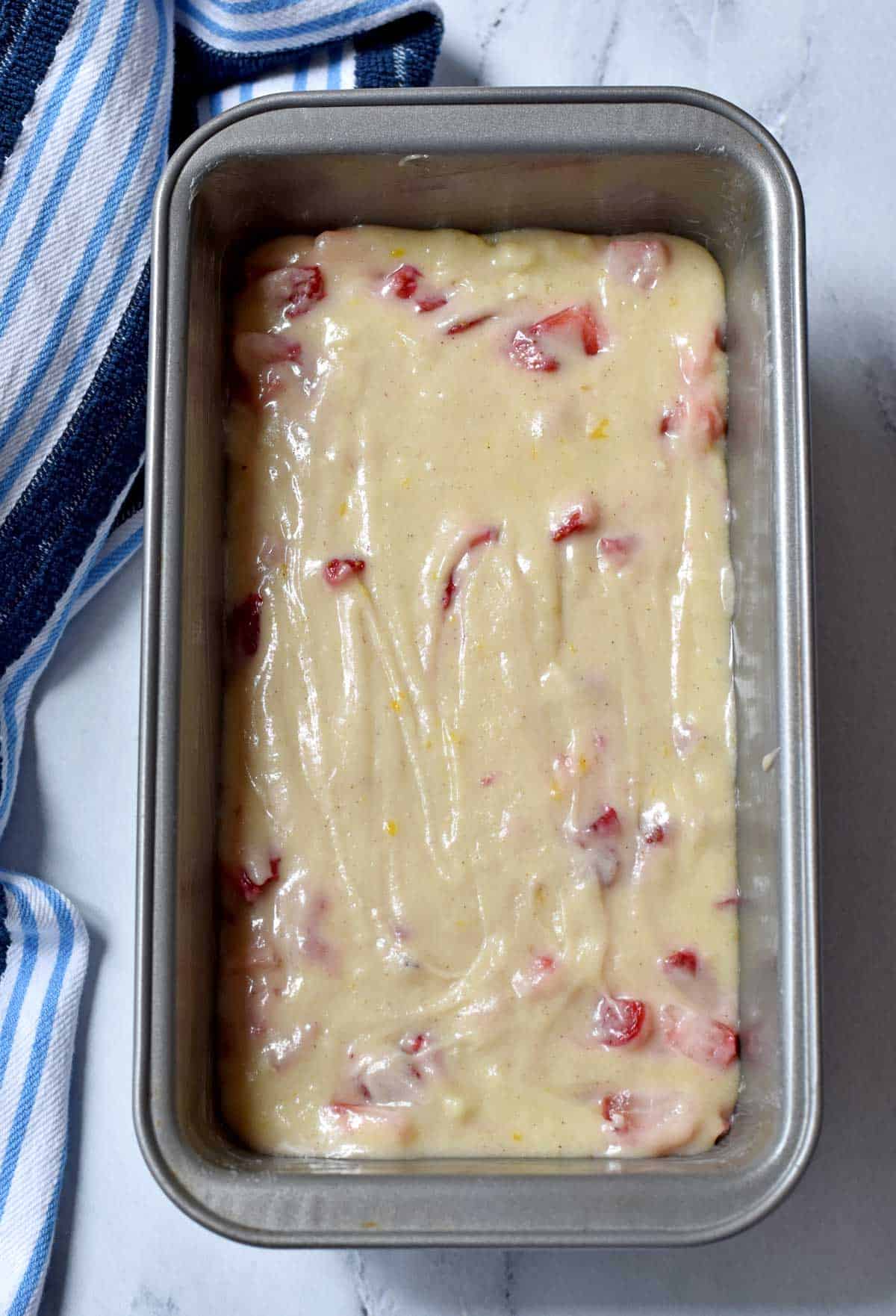 Gluten free strawberry bread batter in greased loaf pan.