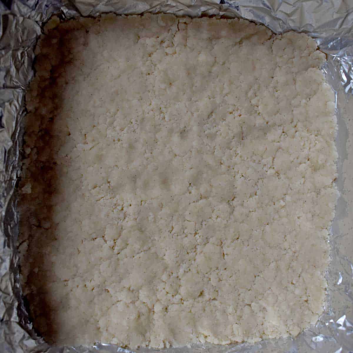 Unbaked gluten free shortbread crust in pan for lemon bars