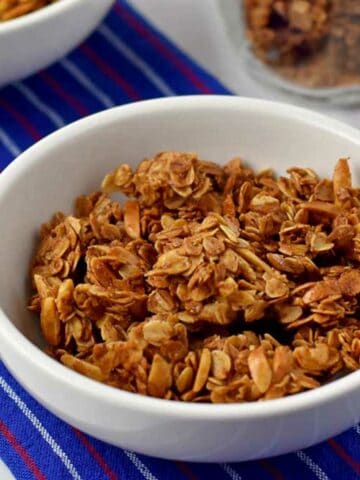 White cereal bowl filled with vanilla almond granola.