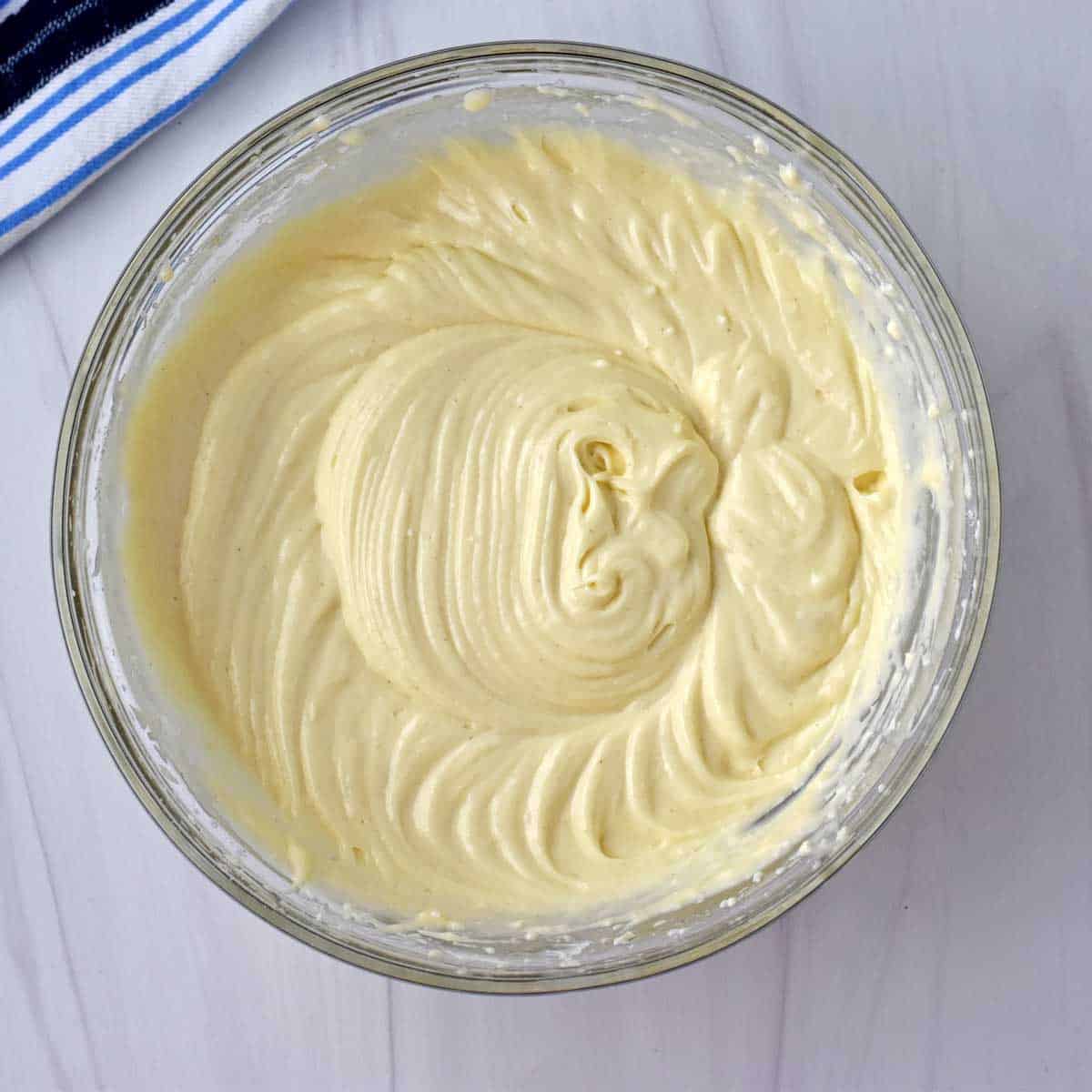 Cream cheese filling in glass mixing bowl.