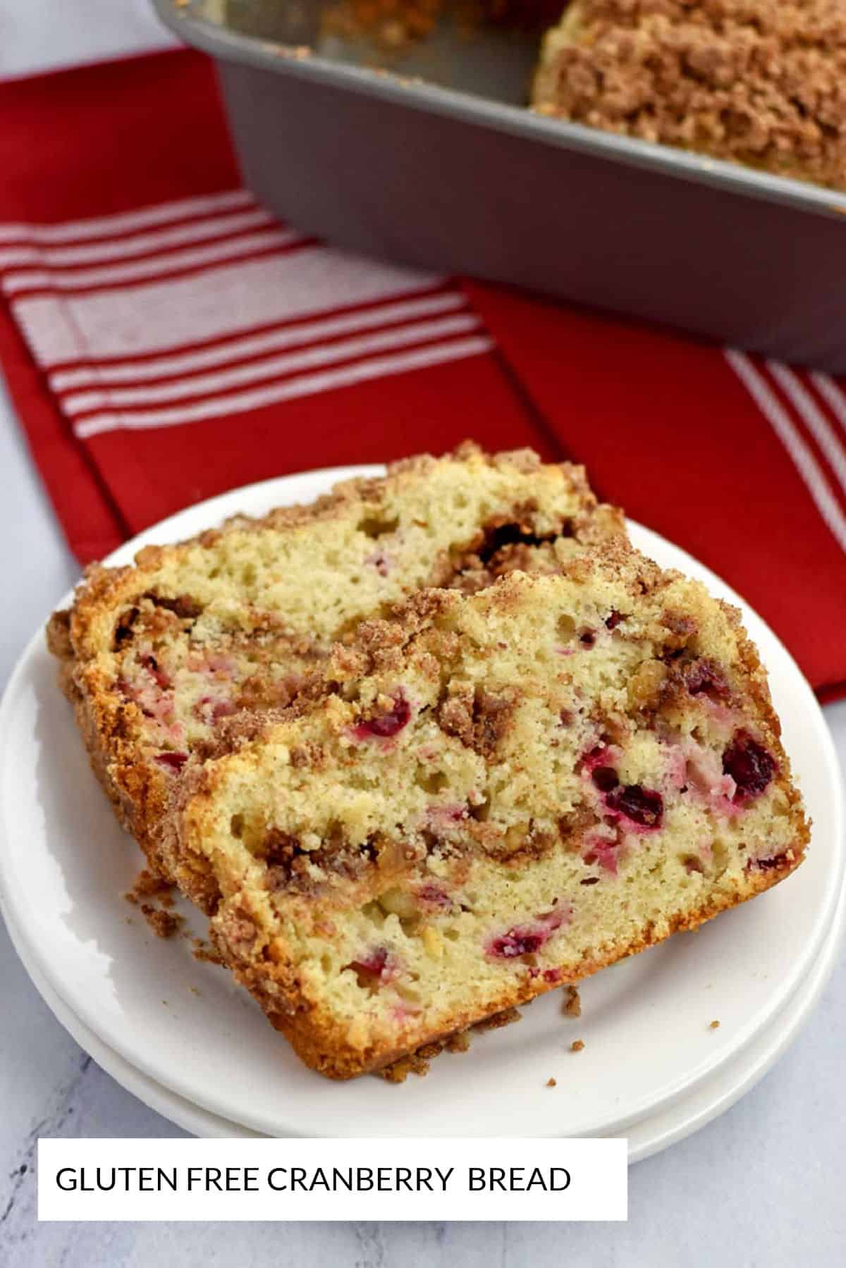 Two slices of gluten free cranberry bread on a stack of round white plates.